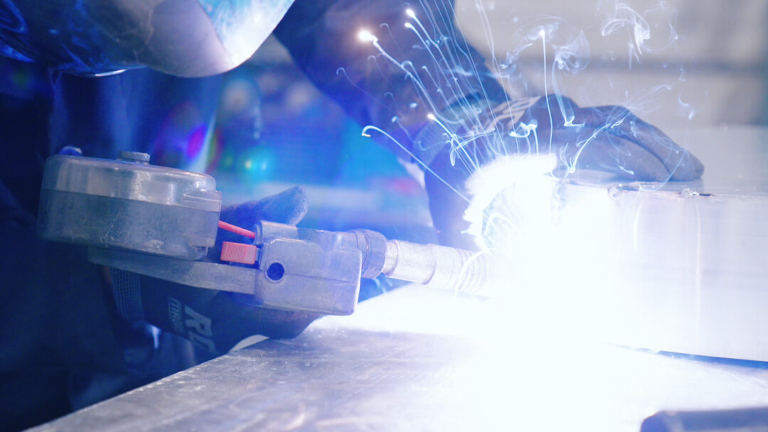 Welder welding metal pieces